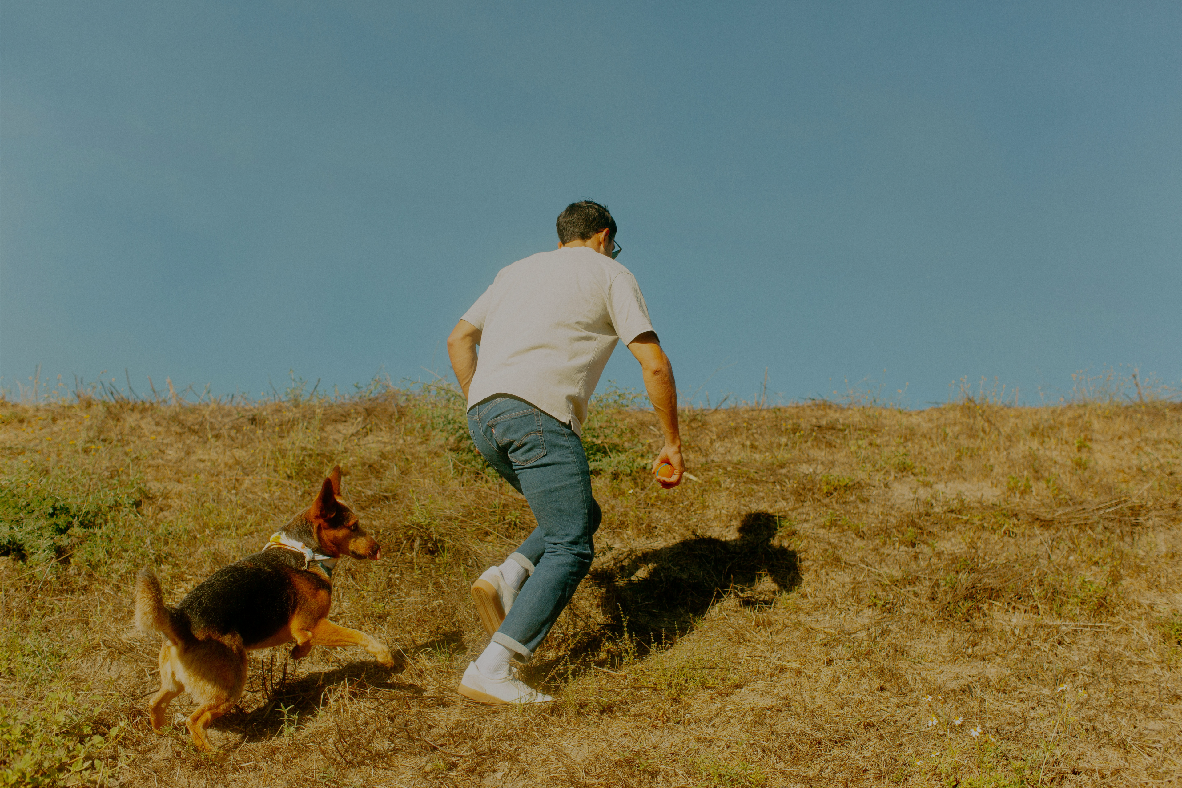 man running with dog