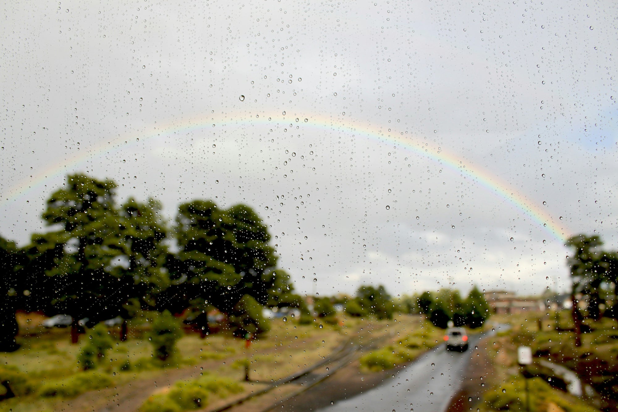 rainbow outside of rainy window