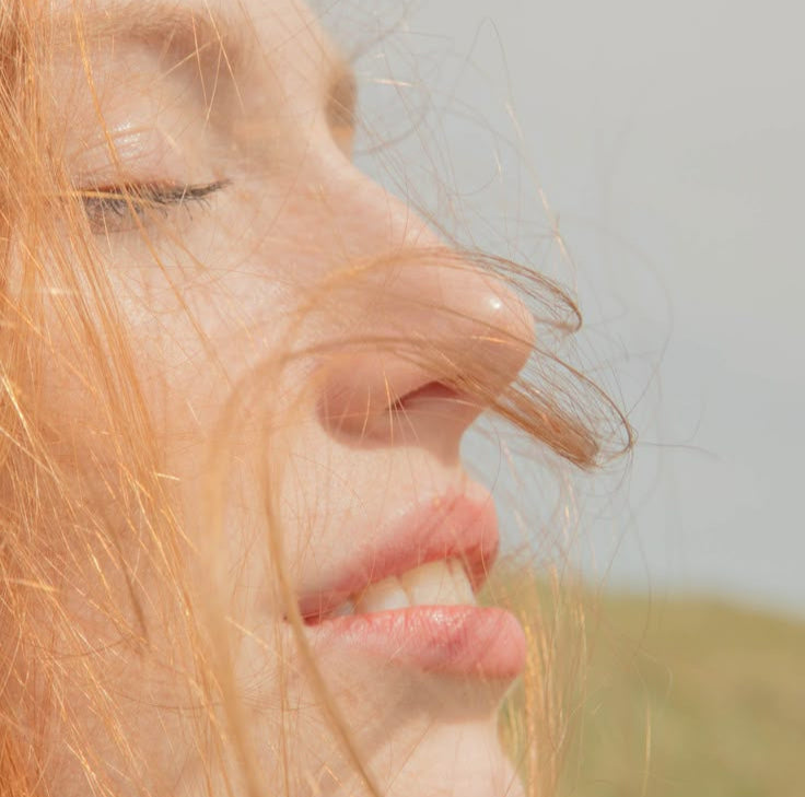 woman with eyes closed in sun